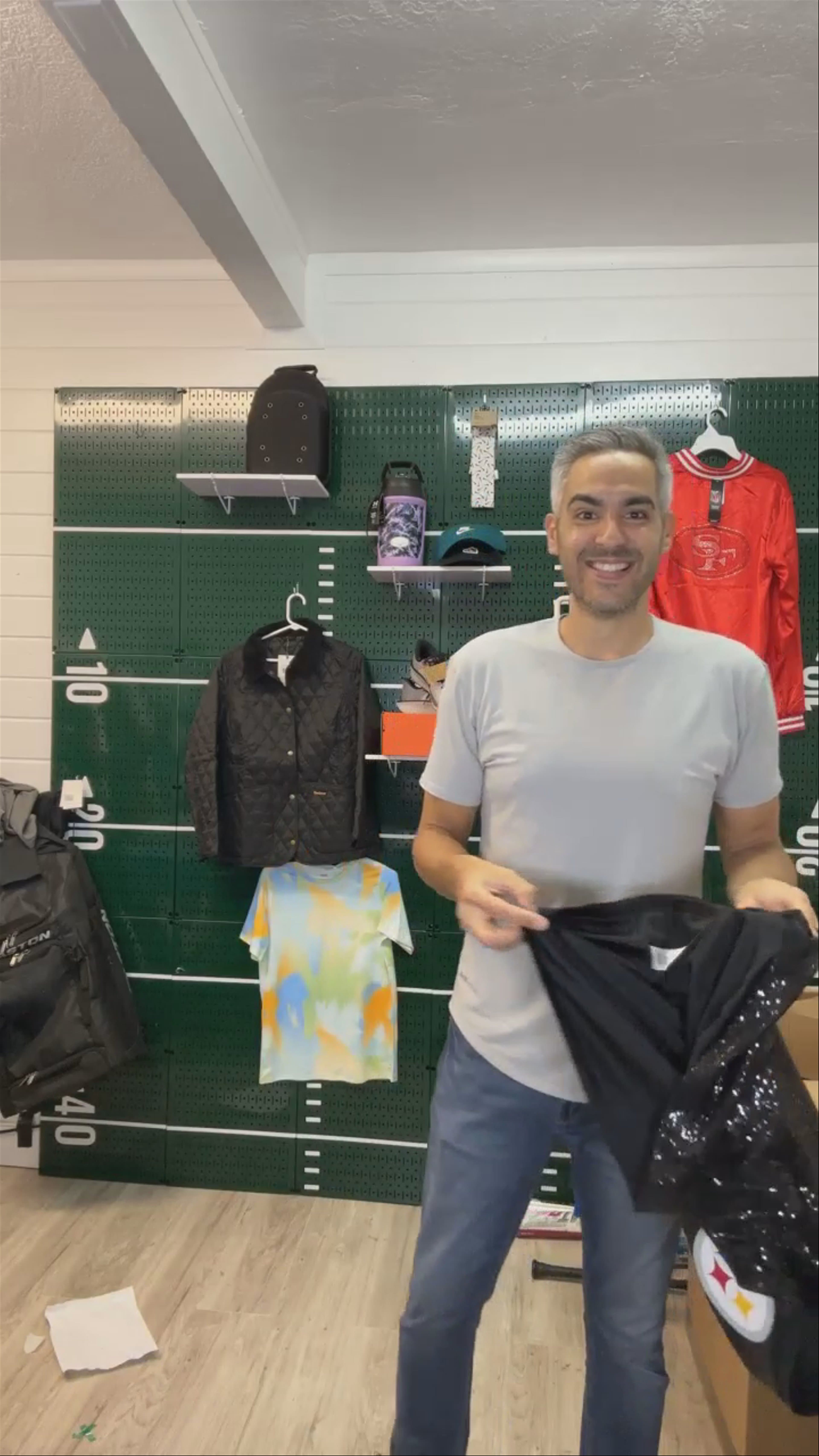 Halftime Sports host showcasing sports merchandise